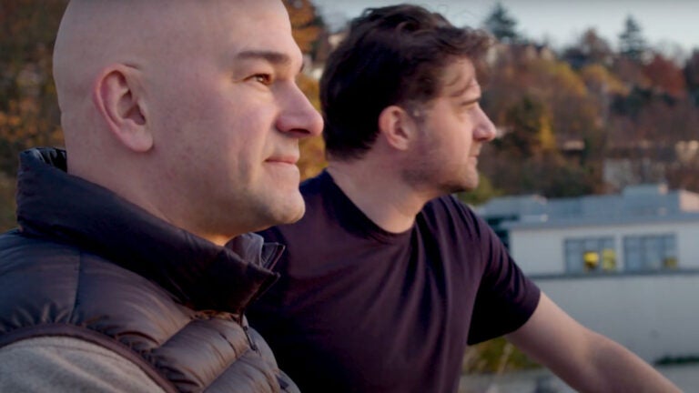 Chad and Harlan Robins look out over the lake