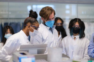 Lab workers teaching the SPIN Girls Fellows how to work with a 3d Printer
