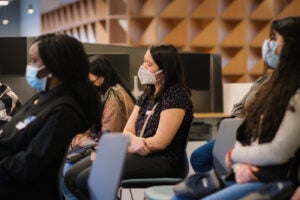 A participant in the SPIN Girls Fellows listens to a volunteer presentation